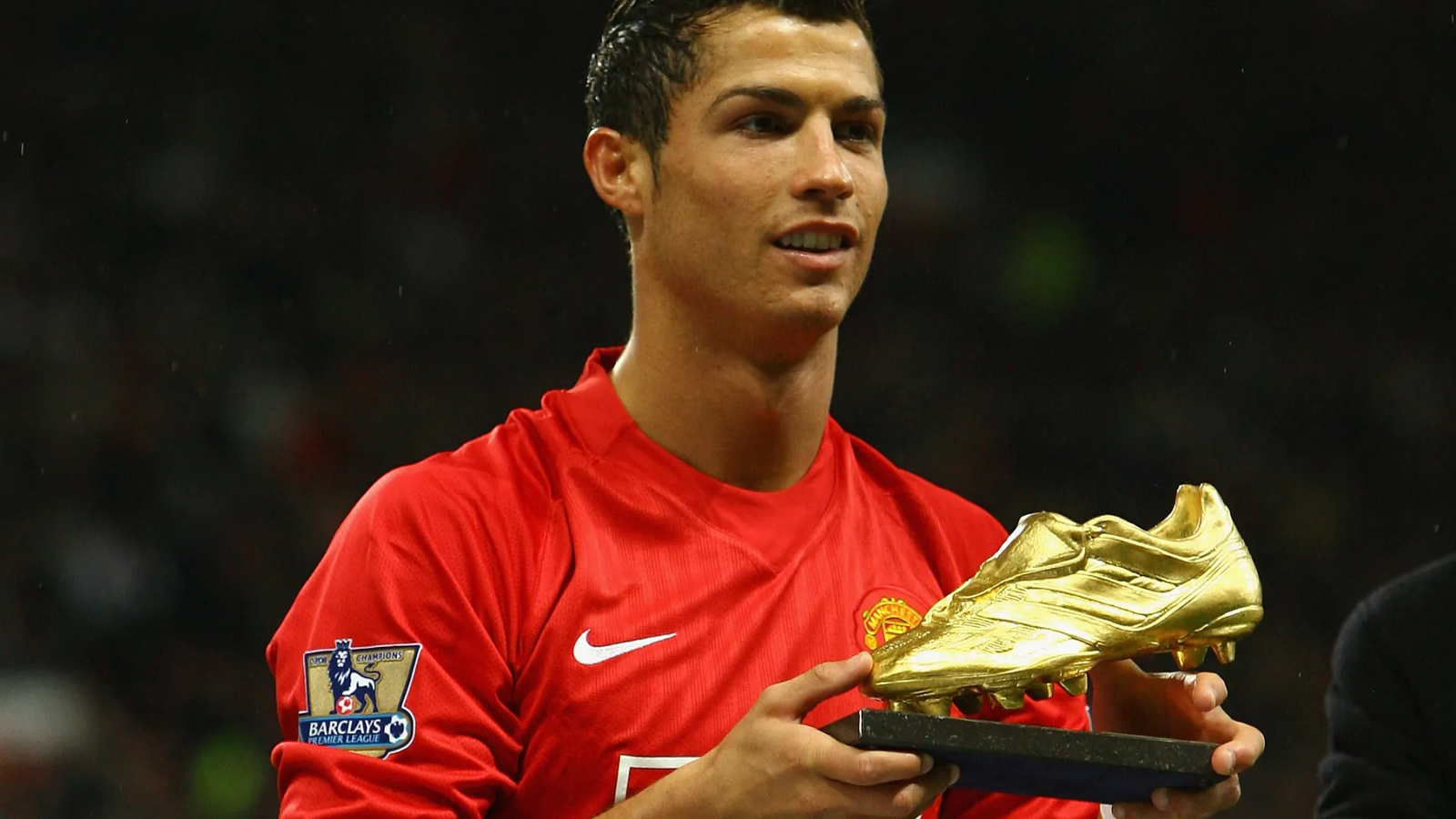 Cristiano Ronaldo holding the Premier League Golden Boot award.