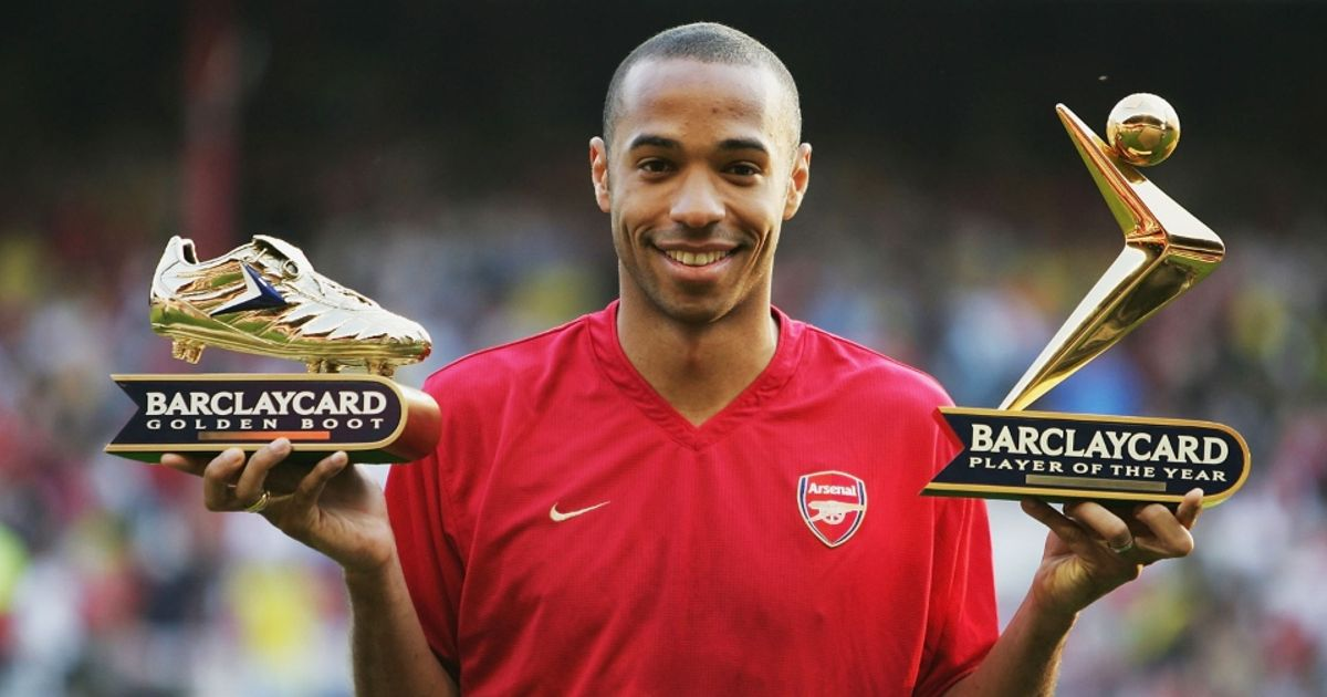 Thiery Henry holding the Premier League Golden Boot and Player of the year awards.